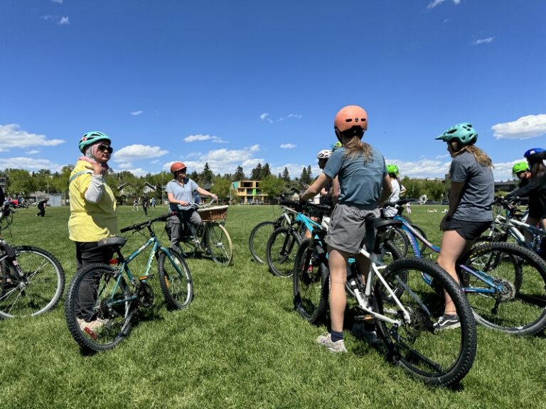 Group of teachers and students prepare to embark on a bicycle ride.