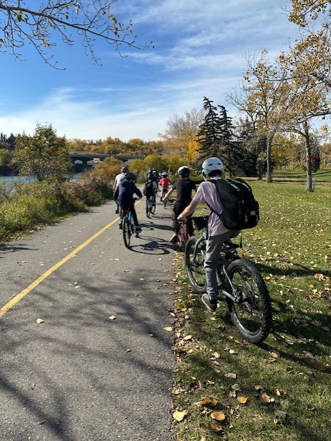 students on bikes ride on a pathway