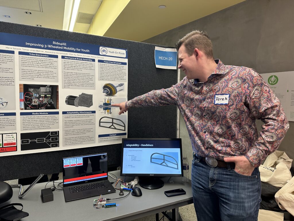 man points to a drawing of improved drive train mechanism