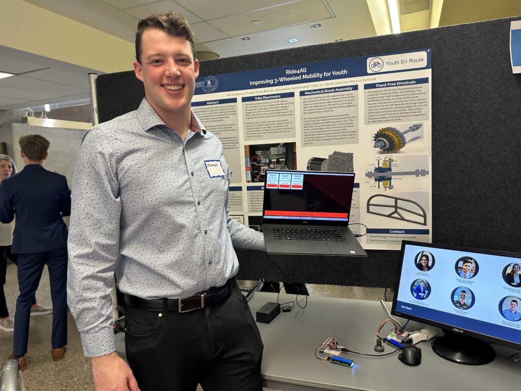 man holds computer with remote interface to slow and stop trikes