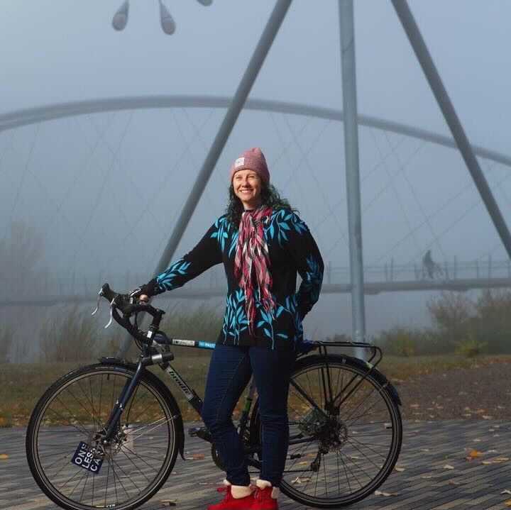 Woman stands with bike