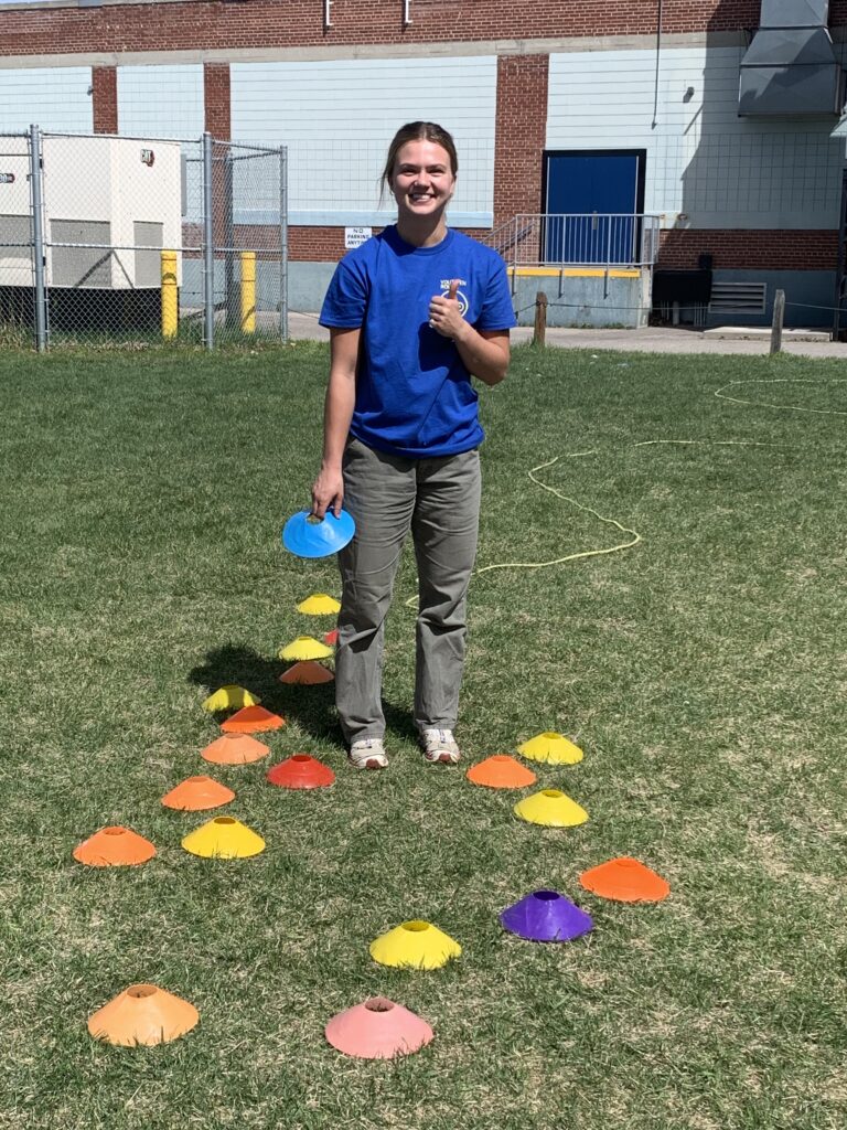 Mia helping out with activities while she teaches students to ride at a local high school.